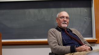 Isenberg professor instructing in-person classroom.