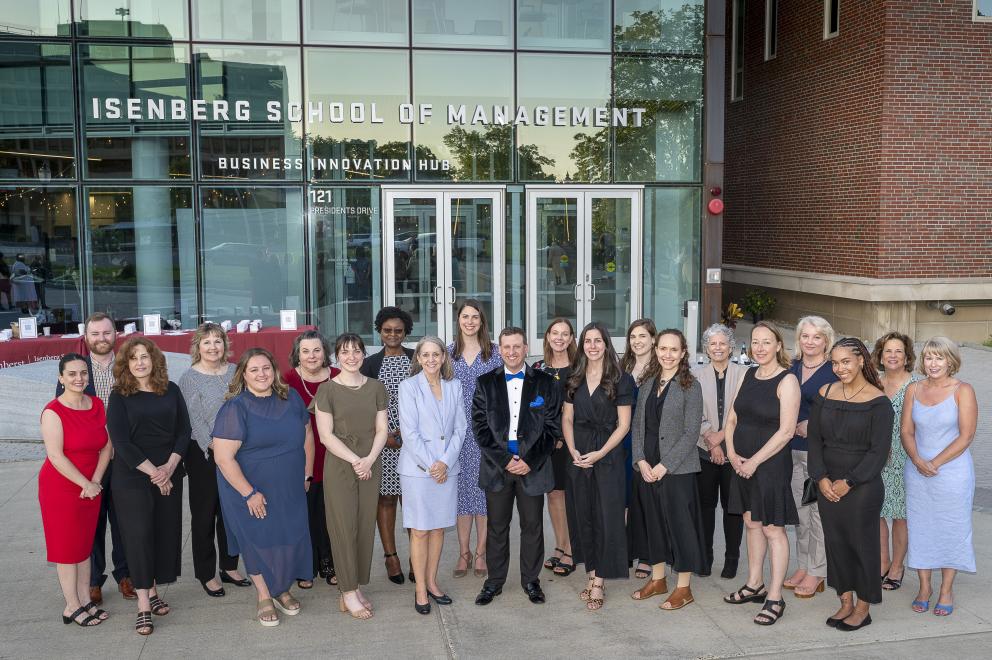 Graduate programs faculty and staff pose outside of the Isenberg HUB.