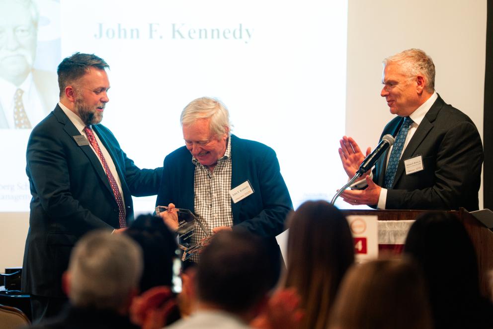 Bradley Bennett and Bill Brown present John Kennedy with Award